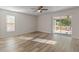 Living room featuring wood-look floors and sliding doors to patio at 13303 Pinyon Dr, Clermont, FL 34711