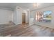 Bright living room with vaulted ceiling, laminate flooring, and access to other rooms at 13303 Pinyon Dr, Clermont, FL 34711