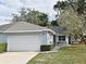 Cute light blue home with 2 car garage, walkway, and well-manicured lawn at 1335 Landry Cir, Longwood, FL 32750