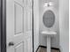 Simple bathroom with pedestal sink and round mirror at 15211 Willow Arbor Cir, Orlando, FL 32824