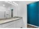 Double vanity bathroom with modern finishes and blue accent wall at 15211 Willow Arbor Cir, Orlando, FL 32824