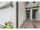 Front entry of townhome with double doors and brick walkway at 15211 Willow Arbor Cir, Orlando, FL 32824