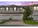 Two-story townhome with two-car garage and landscaped front yard at 15211 Willow Arbor Cir, Orlando, FL 32824