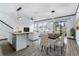 Open-concept kitchen and living area with island and modern lighting at 15211 Willow Arbor Cir, Orlando, FL 32824