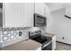 Modern kitchen with stainless steel appliances and geometric backsplash at 15211 Willow Arbor Cir, Orlando, FL 32824