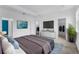 Main bedroom with large bed, walk-in closet, and TV at 15211 Willow Arbor Cir, Orlando, FL 32824
