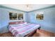 Bedroom with light blue walls and wood-look floors at 1741 Kings Hwy, Kissimmee, FL 34744