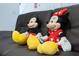 Mickey and Minnie Mouse plush toys on a brown couch at 2194 Cooper Bell Pl, Kissimmee, FL 34747