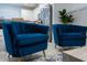 Two blue velvet armchairs with gold legs in the living room at 2194 Cooper Bell Pl, Kissimmee, FL 34747