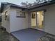 Back exterior view of house showing sliding glass doors leading to a patio at 2801 Kinnon Dr, Orlando, FL 32817