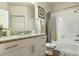 Clean bathroom with granite countertops, white cabinets, and a shower/tub combo at 3214 Gold Ln, Kissimmee, FL 34747