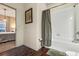 Clean bathroom with a tub, shower, and wood flooring at 3214 Gold Ln, Kissimmee, FL 34747