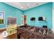 Bright game room with foosball table, chalkboard, and TVs at 3214 Gold Ln, Kissimmee, FL 34747