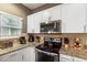 Modern kitchen with stainless steel appliances and granite countertops at 3214 Gold Ln, Kissimmee, FL 34747