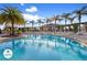 Community pool with lounge chairs and tropical landscaping at 3214 Gold Ln, Kissimmee, FL 34747
