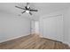 Bedroom with hardwood floors, double door closet and ceiling fan at 5016 Dorman Rd, Lakeland, FL 33813