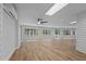 Large Gathering room with wood-look floors, ceiling fan, and plenty of natural light at 5016 Dorman Rd, Lakeland, FL 33813
