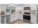 White kitchen with stainless steel appliances and granite countertops at 5016 Dorman Rd, Lakeland, FL 33813