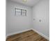 Bright laundry room with wood-look flooring and built-in shelving at 5016 Dorman Rd, Lakeland, FL 33813