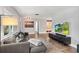 Living room with hardwood floors and large TV at 510 Cocoa Ln, Orlando, FL 32804