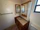 Bathroom with sink, double mirror, and wood vanity at 857 E Flag Ln, Kissimmee, FL 34759