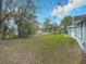 Large backyard with grassy area and wooden fence at 143 N Woodward Ave, Deland, FL 32720