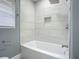 Bathroom with a bathtub and marble-look tile at 143 N Woodward Ave, Deland, FL 32720
