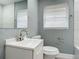 Updated bathroom with white vanity and gray walls at 143 N Woodward Ave, Deland, FL 32720