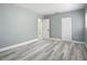 Spacious bedroom with wood-look floors and neutral walls at 143 N Woodward Ave, Deland, FL 32720