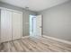 Bedroom with double-door closet and wood-look floors at 143 N Woodward Ave, Deland, FL 32720