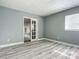 Bedroom with French doors and wood-look floors at 143 N Woodward Ave, Deland, FL 32720