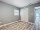 Bedroom with double-door closet and wood-look floors at 143 N Woodward Ave, Deland, FL 32720