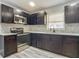 Updated kitchen with dark cabinets and quartz countertops at 143 N Woodward Ave, Deland, FL 32720