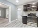 Modern kitchen with stainless steel appliances and gray cabinetry at 143 N Woodward Ave, Deland, FL 32720