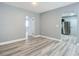 Open concept living area with new flooring and doors to other rooms at 143 N Woodward Ave, Deland, FL 32720