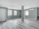 Bright living room featuring wood-look floors and neutral walls at 143 N Woodward Ave, Deland, FL 32720