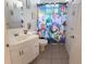 Clean bathroom with a white vanity, a Toy Story themed shower curtain, and white tile at 2749 N Poinciana Blvd # 16, Kissimmee, FL 34746