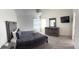 Main bedroom with a king-size bed, dresser, and a large TV at 2749 N Poinciana Blvd # 16, Kissimmee, FL 34746