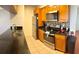 Modern kitchen with granite countertops, stainless steel appliances, and wood cabinets at 2749 N Poinciana Blvd # 16, Kissimmee, FL 34746