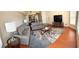 Bright living room featuring hardwood floors, comfortable sofas, and a large TV at 2749 N Poinciana Blvd # 16, Kissimmee, FL 34746
