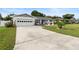 White single story home with attached garage and landscaped lawn at 47 Community Dr, Debary, FL 32713