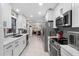 Modern kitchen featuring white cabinets, stainless steel appliances, and quartz countertops at 47 Community Dr, Debary, FL 32713