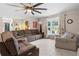 Spacious living room with brown sectional sofa and large window at 47 Community Dr, Debary, FL 32713