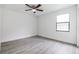 Bright bedroom with ceiling fan and grey wood-look flooring at 5870 Nw 3Rd St, Ocala, FL 34482