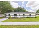 Remodeled single story home with modern exterior, landscaped lawn, and driveway at 5870 Nw 3Rd St, Ocala, FL 34482