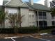 Condo building exterior with multiple units and landscaping at 6106 Westgate Dr # 102, Orlando, FL 32835