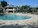 Community pool area with a gazebo and lounge chairs at 6106 Westgate Dr # 102, Orlando, FL 32835