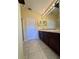 Bathroom with double vanity, dark wood cabinets and tiled floor at 6430 S Goldenrod Rd # 15B, Orlando, FL 32822