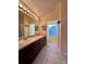 Bathroom with double vanity, dark wood cabinets and tiled floor at 6430 S Goldenrod Rd # 15B, Orlando, FL 32822