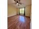 Spacious bedroom with wood-look flooring and large window at 6430 S Goldenrod Rd # 15B, Orlando, FL 32822